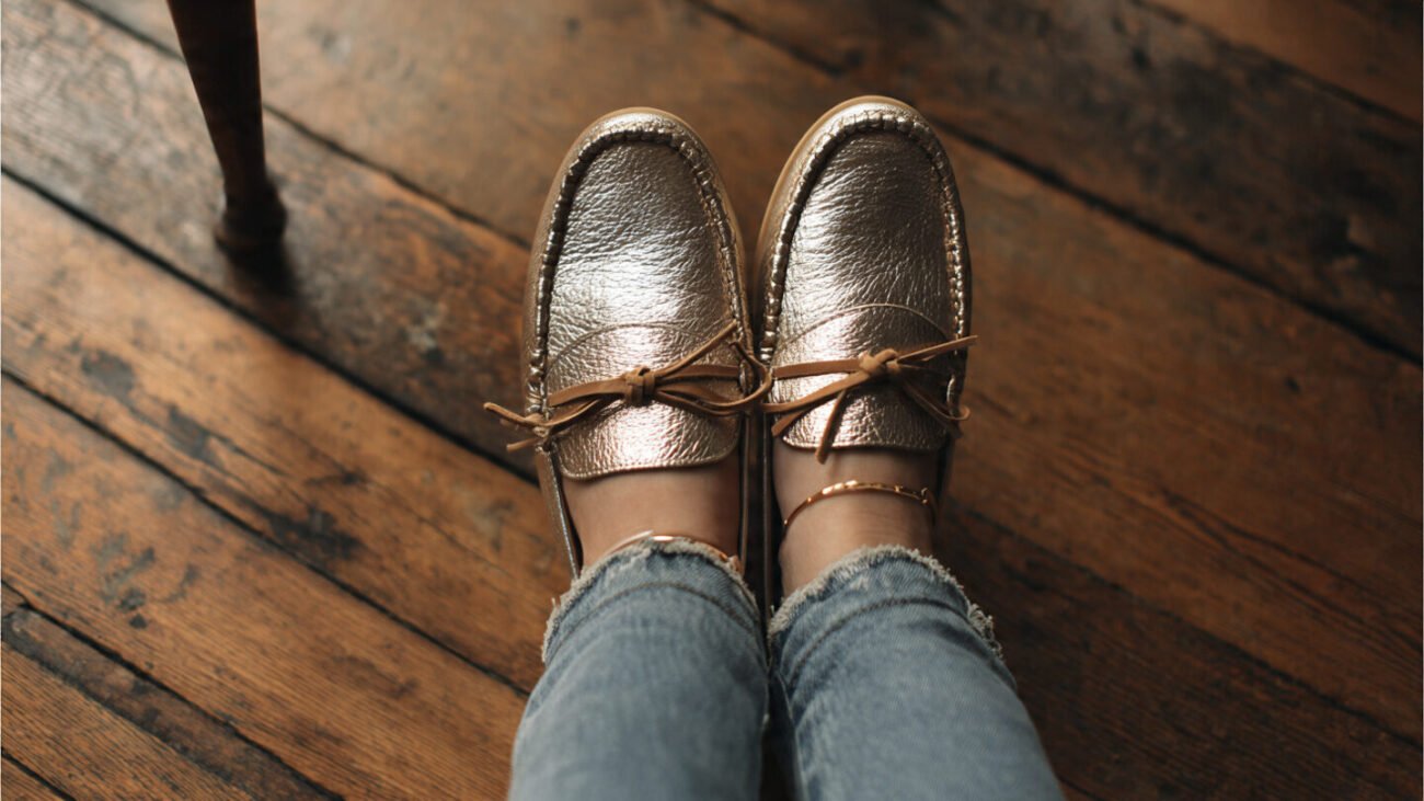 metallic moccasins on wooden flooring with jeans